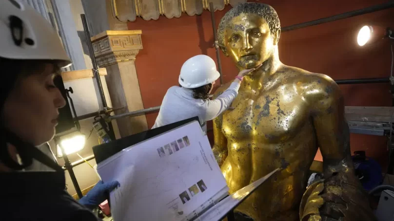 Vatican experts uncovering gilded glory of Roman god of strength statue hit by lightning