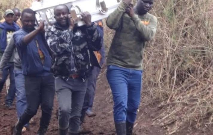Mourners in central Kenya carry casket on shoulders after heavy rains render road impassable
