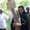 Young pastoralist woman joins tree-hugging frenzy to speak out against gender violence in highly patriarchal northern Kenya