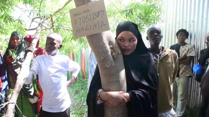 Young pastoralist woman joins tree-hugging frenzy to speak out against gender violence in highly patriarchal northern Kenya